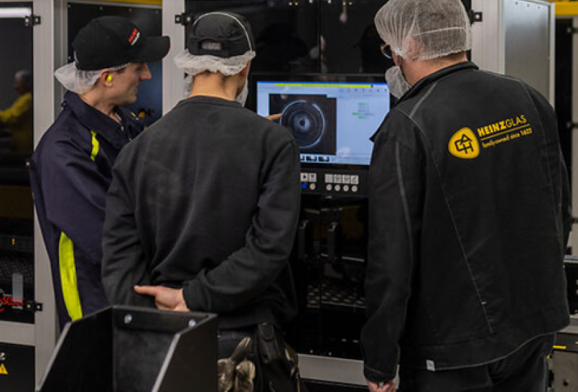 Group of people working in front of screen of inspection machine